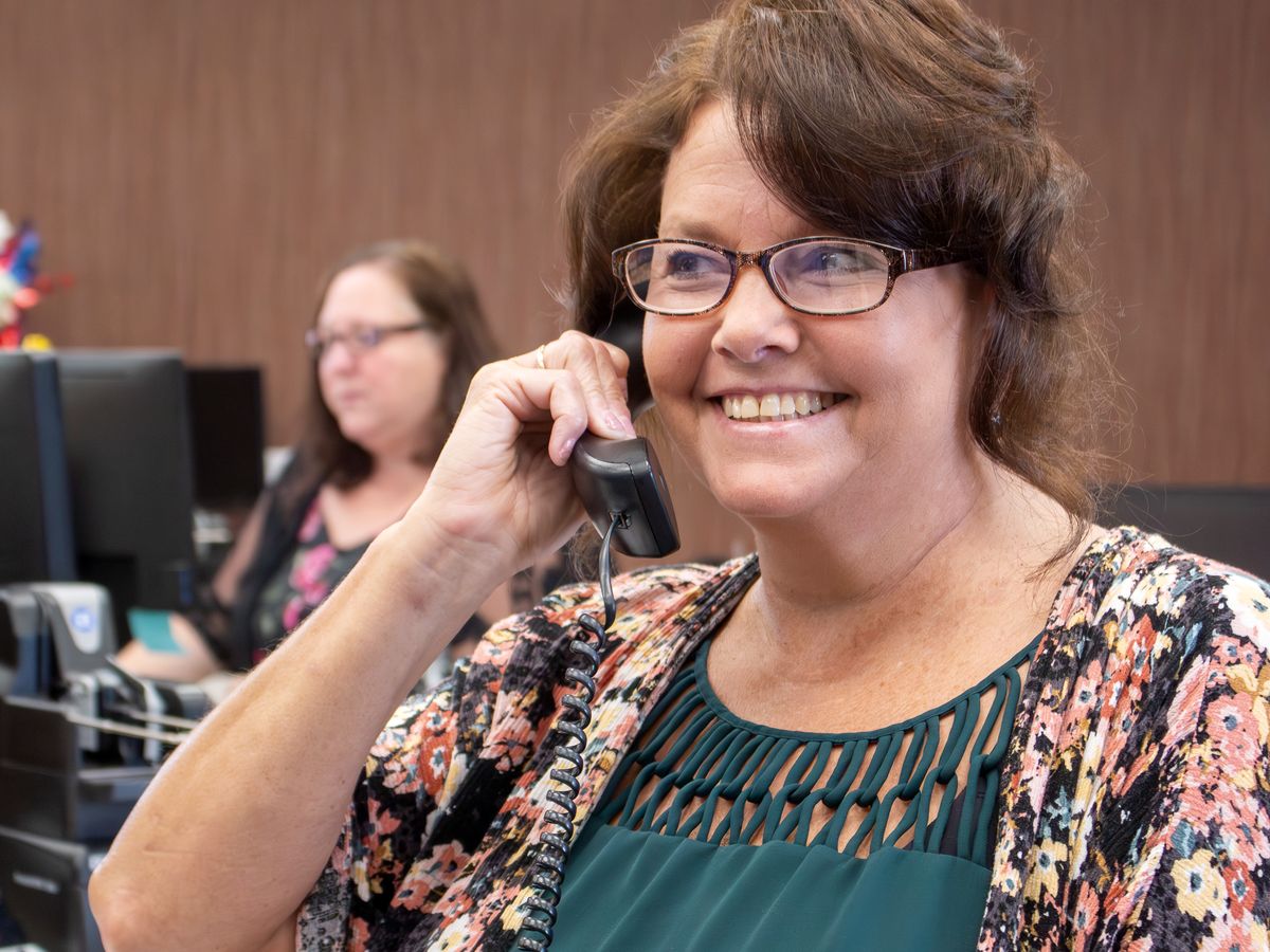 A Greenville Savings Bank employee taking a customer call