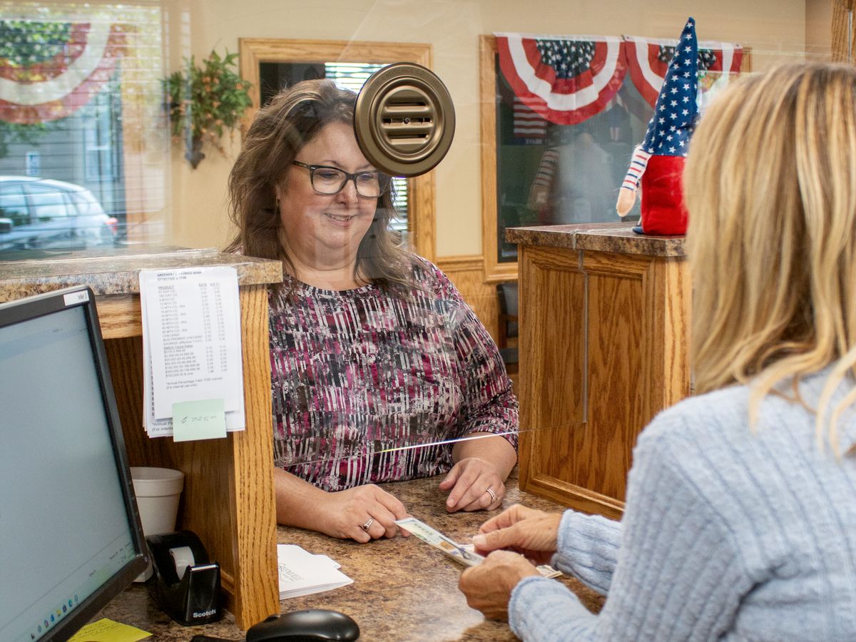 A Greenville Savings Bank teller helping someone at the New Wilmington counter