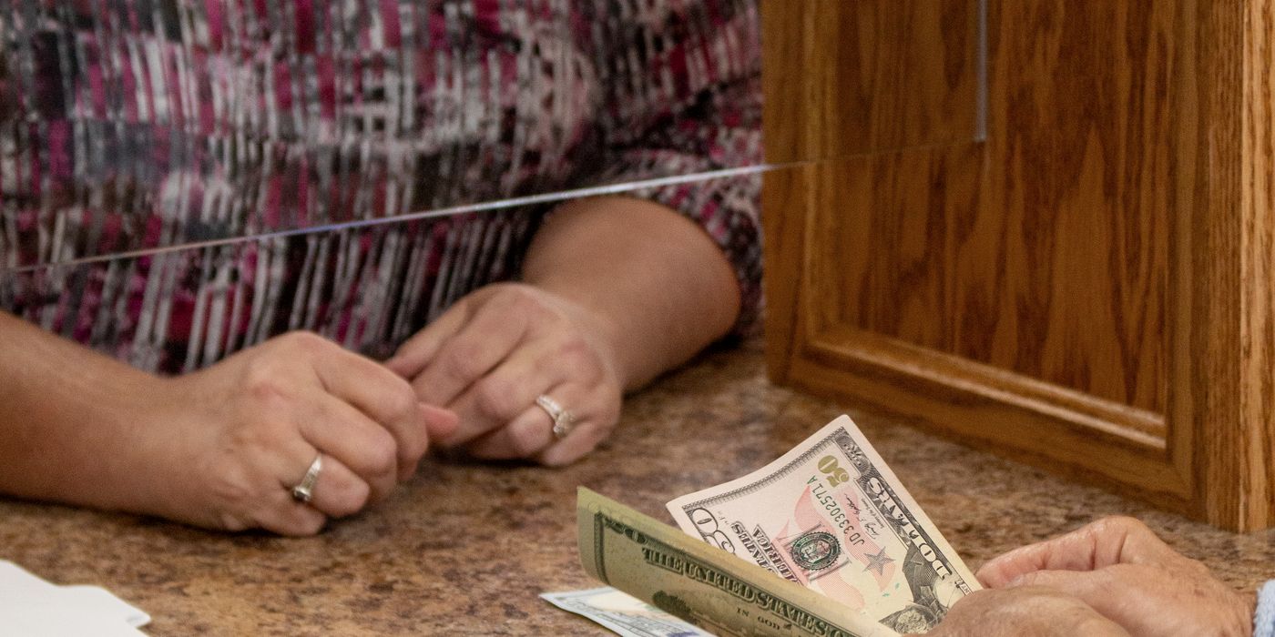 Cash passed across the teller counter