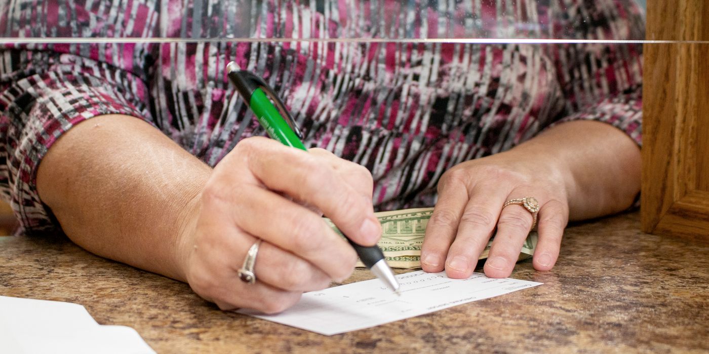 Writing a check at the teller counter